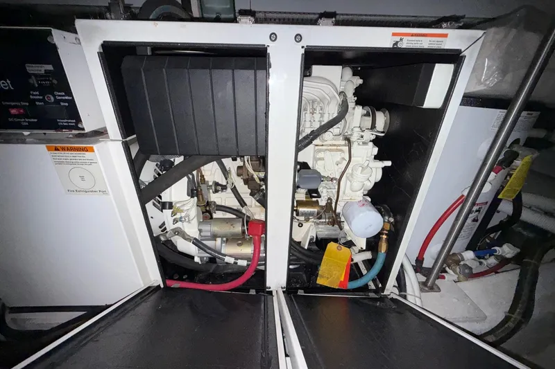  Yacht Photos Pics Engine room of a 2002 Carver 570 Voyager Pilothouse, showcasing mechanical components and wiring.