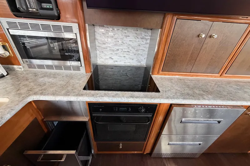  Yacht Photos Pics Modern kitchen in 2002 Carver 570 Voyager Pilothouse with appliances and wood cabinetry.