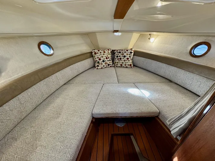  Yacht Photos Pics 2023 Ranger Tugs R-25 cabin interior with cozy seating and decorative pillows.