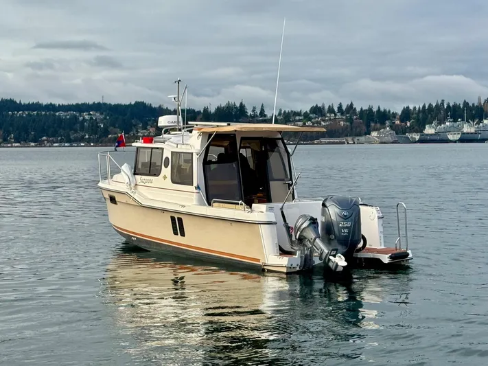  Yacht Photos Pics 2023 Ranger Tugs R-25 boat on calm water with scenic background.