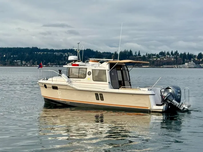  Yacht Photos Pics 2023 Ranger Tugs R-25 boat on calm water with scenic background.