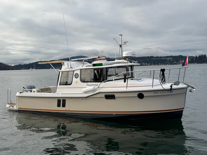  Yacht Photos Pics 2023 Ranger Tugs R-25 boat on calm water, overcast sky.