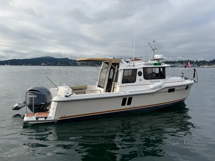  Yacht Photos Pics 2023 Ranger Tugs R-25 boat on calm water, overcast sky.