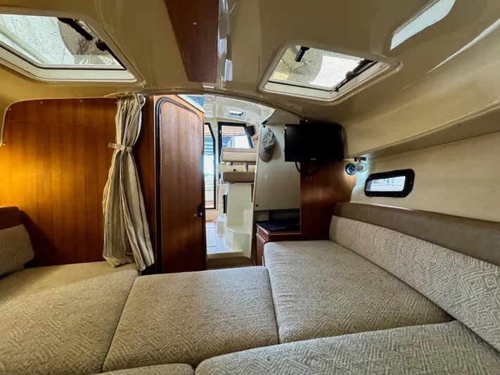  Yacht Photos Pics 2023 Ranger Tugs R-25 interior cabin with cozy seating and natural light.