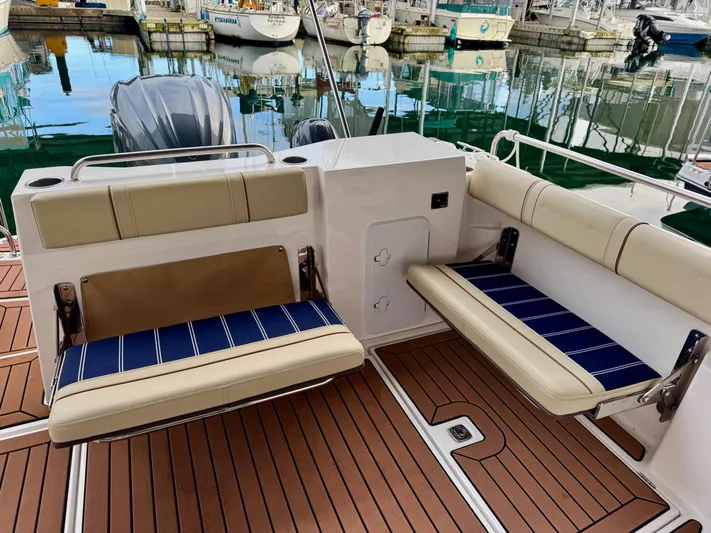  Yacht Photos Pics 2023 Ranger Tugs R-25 boat interior with foldable seating and teak flooring.