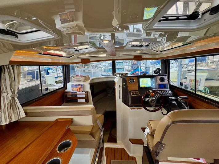  Yacht Photos Pics Interior of 2023 Ranger Tugs R-25 boat, featuring modern helm and seating area.