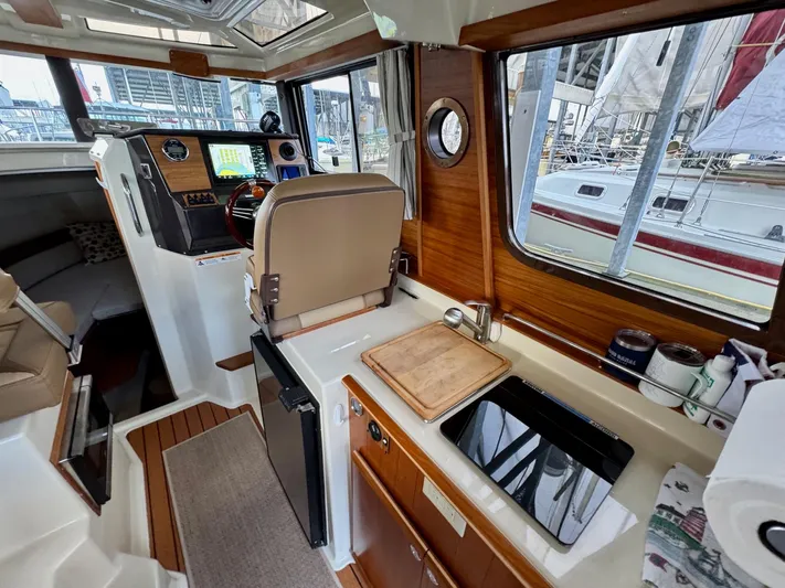 Yacht Photos Pics Interior of 2023 Ranger Tugs R-25 boat with modern helm and kitchenette.