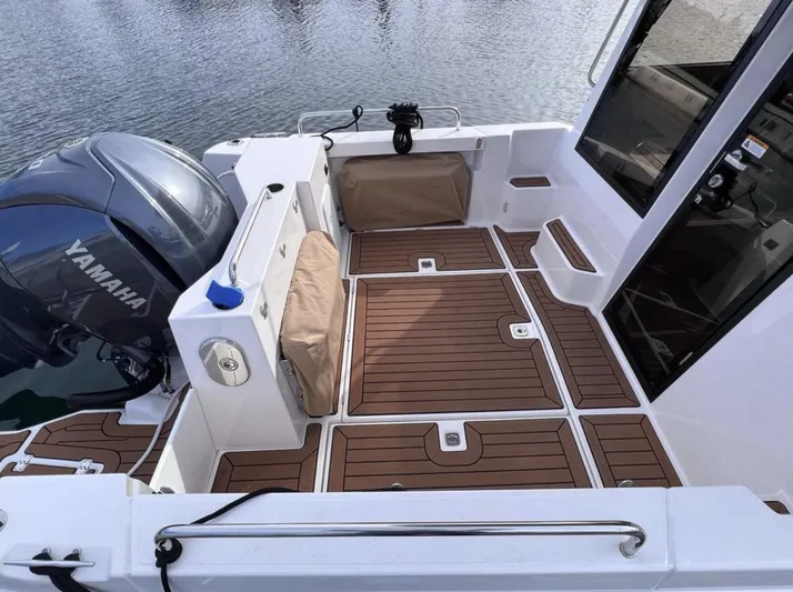  Yacht Photos Pics 2023 Ranger Tugs R-25 boat deck with Yamaha engine, featuring teak flooring.