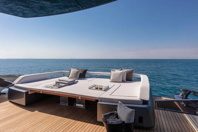  Yacht Photos Pics Luxurious 2025 Riva Folgore yacht deck with sun loungers overlooking the ocean.
