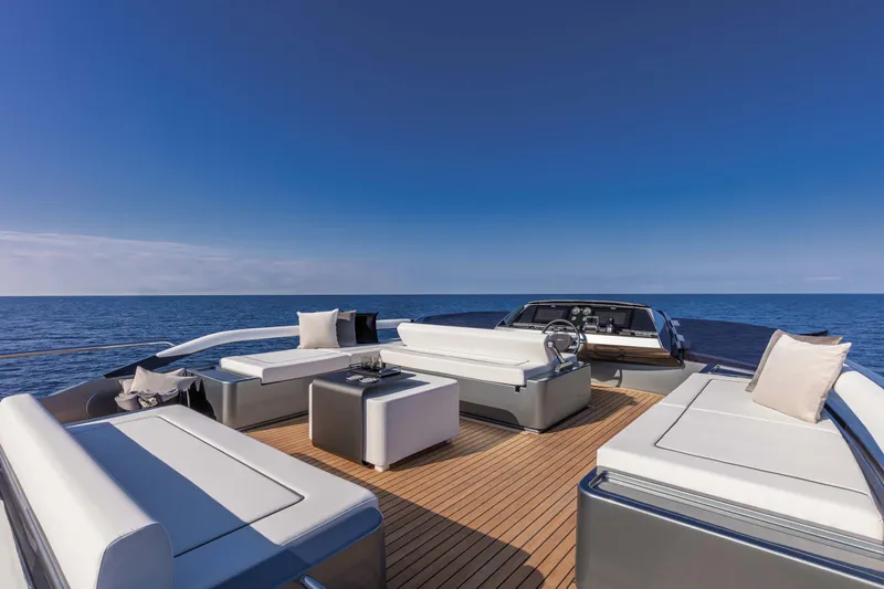  Yacht Photos Pics Luxurious 2025 Riva Folgore yacht deck with elegant seating, overlooking the serene ocean.