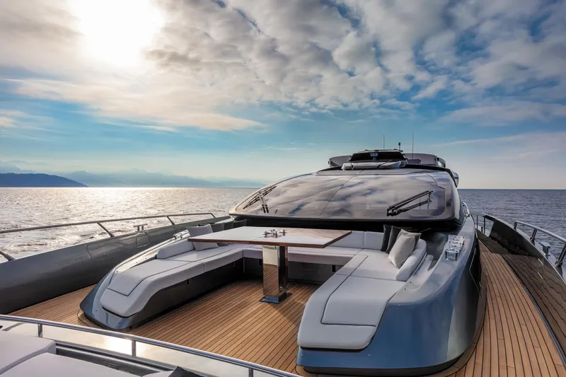  Yacht Photos Pics Luxurious 2025 Riva Folgore yacht on open sea under a vibrant sky.