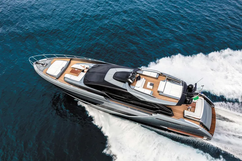  Yacht Photos Pics Luxurious 2025 Riva Folgore yacht cruising on open sea, showcasing sleek design and elegance.