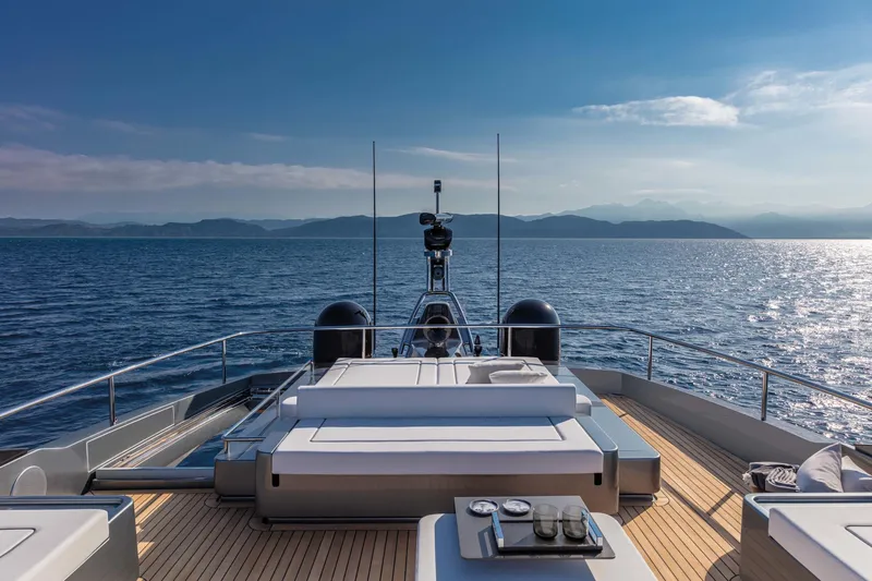  Yacht Photos Pics Luxurious 2025 Riva Folgore yacht cruising on open sea under clear blue sky.