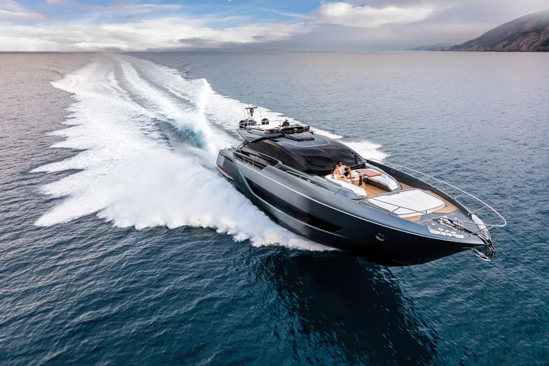  Yacht Photos Pics Luxury 2025 Riva Folgore yacht cruising on open sea under clear skies.