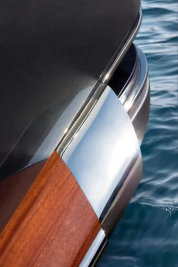  Yacht Photos Pics 2025 Riva Folgore yacht detail with sleek wood and metal design on water.