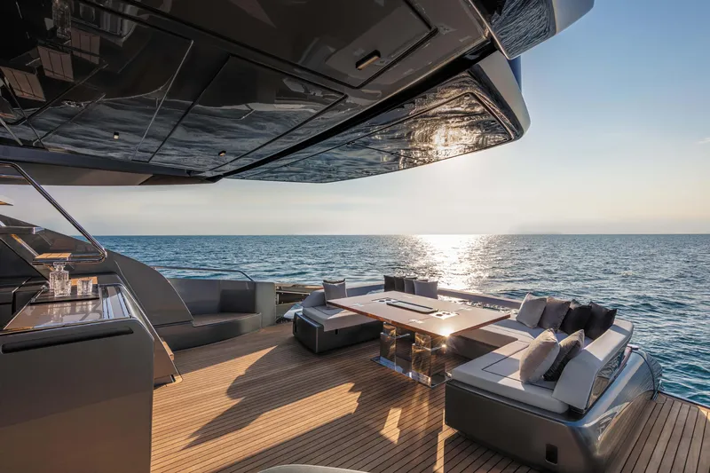  Yacht Photos Pics Luxurious 2025 Riva Folgore yacht deck with ocean view at sunset.