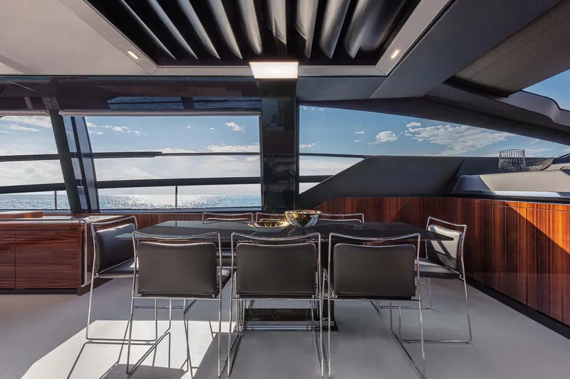  Yacht Photos Pics Luxurious 2025 Riva Folgore yacht interior with sleek dining area and ocean view.