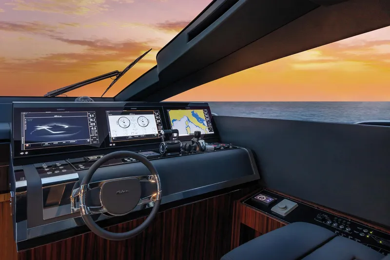  Yacht Photos Pics Helm of 2025 Riva Folgore yacht with modern navigation screens at sunset.