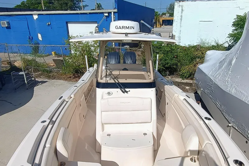 271-508 Brokerage Joe Yacht Photos Pics 2023 Grady-White Canyon 271 boat with Garmin equipment, docked outdoors.