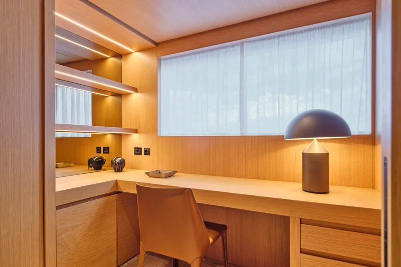M/y K2 Yacht Photos Pics Luxurious Sanlorenzo SD118/156 yacht interior, 2024 model, featuring elegant wooden desk and modern lamp.