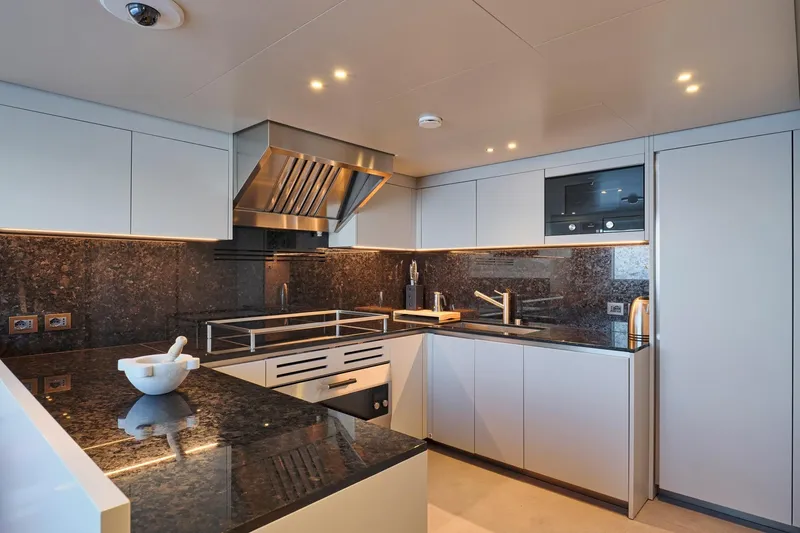 M/y K2 Yacht Photos Pics Modern kitchen interior on 2024 Sanlorenzo SD118/156 yacht, featuring sleek cabinetry and granite countertops.