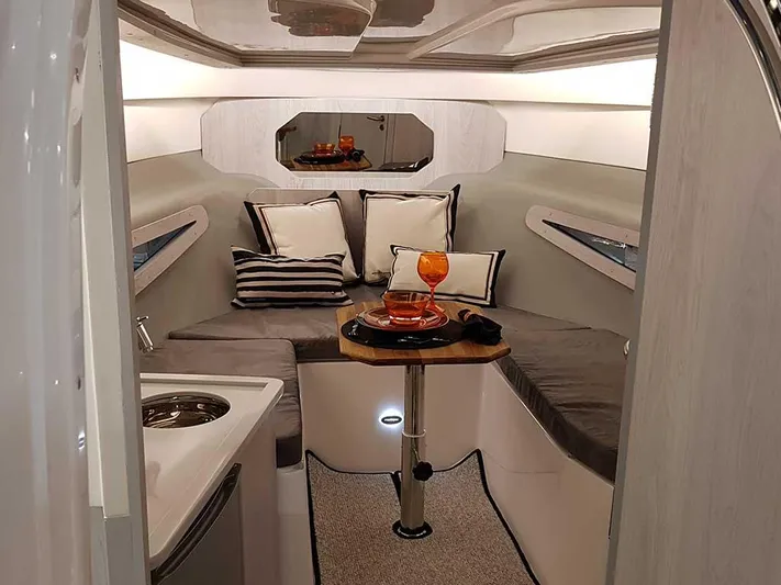 Custom Order Yours Today! Yacht Photos Pics Luxurious interior of 2025 Hanover 355 Outboard boat with cozy seating and elegant decor.