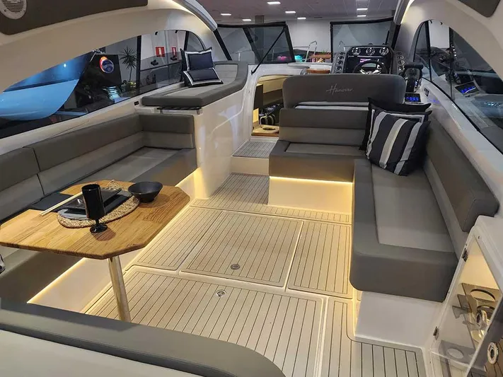 Custom Order Yours Today! Yacht Photos Pics Luxurious interior of 2025 Hanover 355 Outboard boat with elegant seating and ambient lighting.