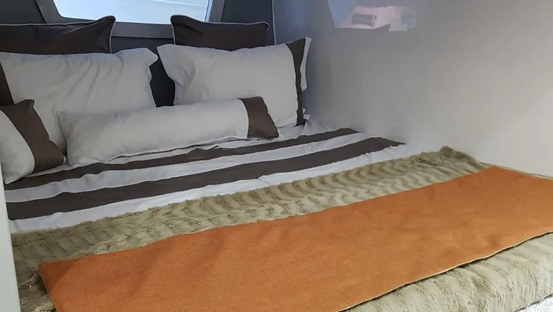 Custom Order Yours Today! Yacht Photos Pics Interior cabin of 2025 Hanover 355 Outboard with cozy bedding and pillows.