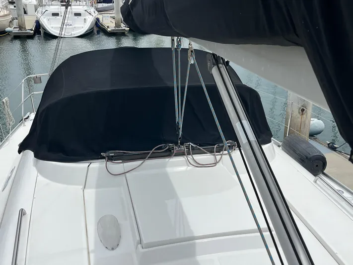 Dragonfly Yacht Photos Pics 2007 Hanse 370e sailboat with black cover docked at marina.