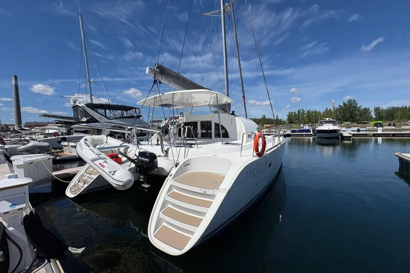 Too Impulsive Yacht Photos Pics 2014 Lagoon 380 S2 catamaran docked at marina under clear blue sky.