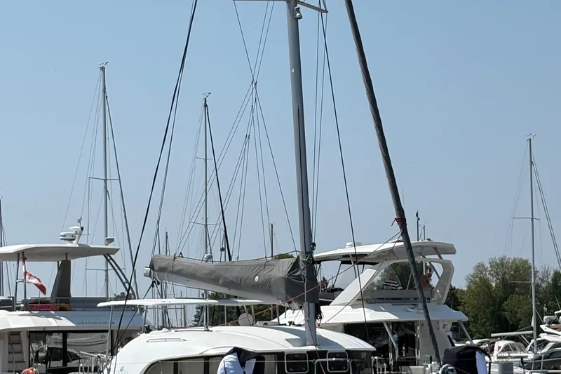 Too Impulsive Yacht Photos Pics 2014 Lagoon 380 S2 catamaran docked at marina with other sailboats.