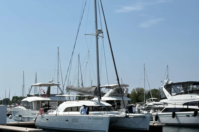 Too Impulsive Yacht Photos Pics 2014 Lagoon 380 S2 catamaran docked at a marina on a sunny day.