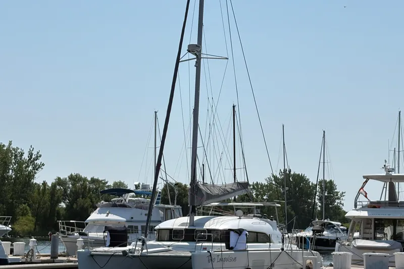 Too Impulsive Yacht Photos Pics 2014 Lagoon 380 S2 catamaran docked at a marina with other boats.
