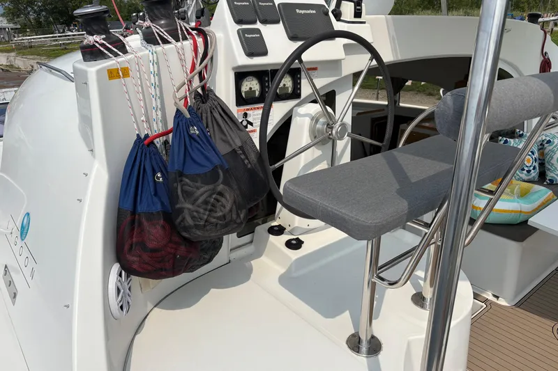 Too Impulsive Yacht Photos Pics Helm station of 2014 Lagoon 380 S2 catamaran with steering wheel and rope bags.