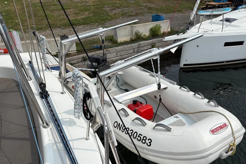 Too Impulsive Yacht Photos Pics 2014 Lagoon 380 S2 catamaran docked with inflatable dinghy attached.