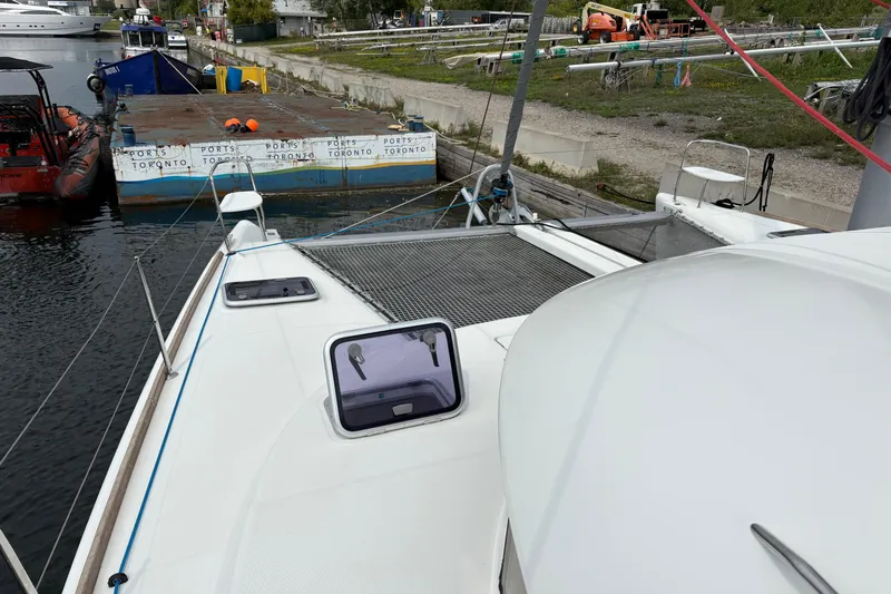 Too Impulsive Yacht Photos Pics 2014 Lagoon 380 S2 catamaran docked in Toronto harbor, featuring deck and hatch view.