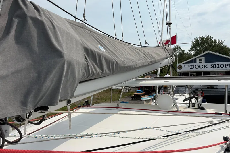 Too Impulsive Yacht Photos Pics 2014 Lagoon 380 S2 sailboat docked near a shop, with covered boom.