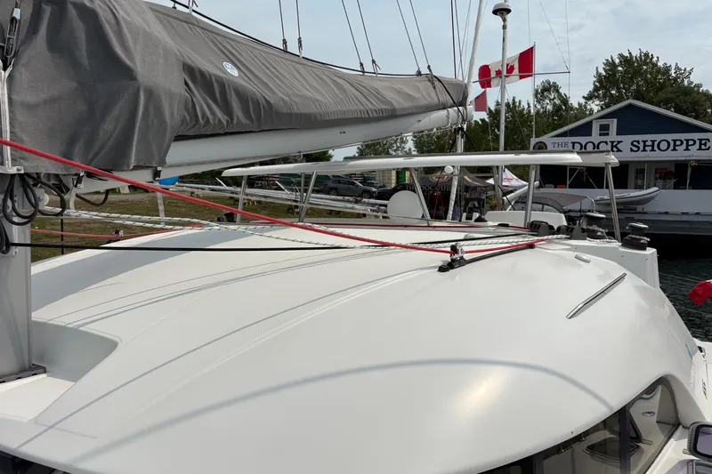 Too Impulsive Yacht Photos Pics 2014 Lagoon 380 S2 catamaran docked near a shop with Canadian flags.