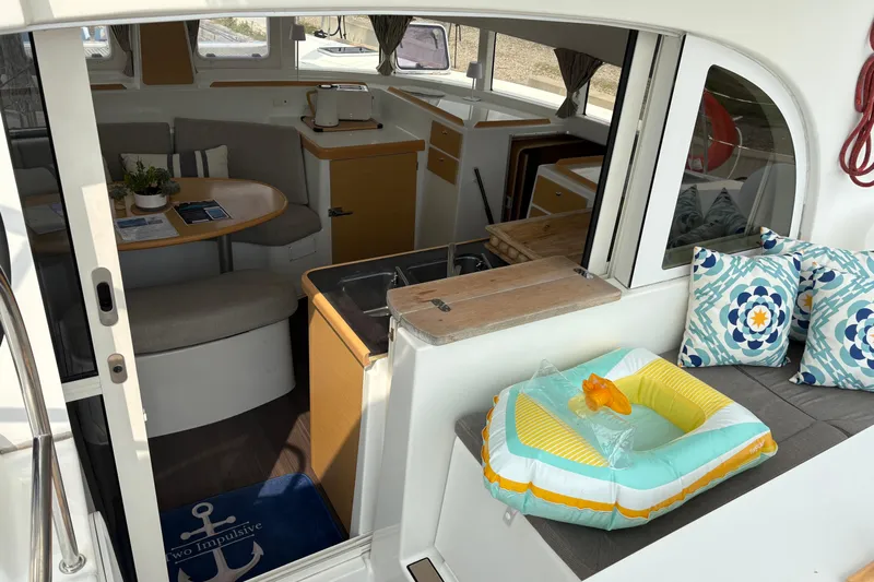 Too Impulsive Yacht Photos Pics Interior of 2014 Lagoon 380 S2 catamaran with cozy seating and nautical decor.