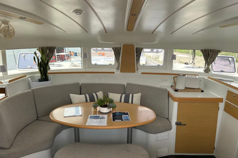 Too Impulsive Yacht Photos Pics Interior of 2014 Lagoon 380 S2 catamaran with cozy seating and dining area.