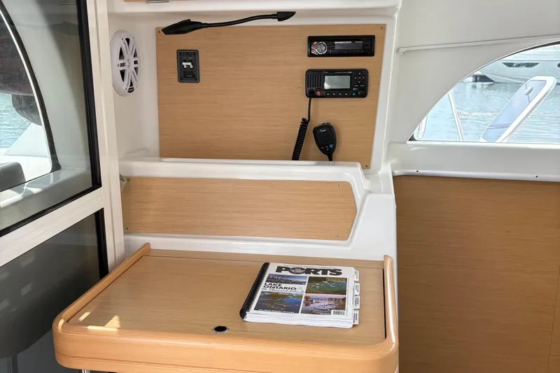 Too Impulsive Yacht Photos Pics Interior of 2014 Lagoon 380 S2 yacht with navigation equipment and magazine on table.