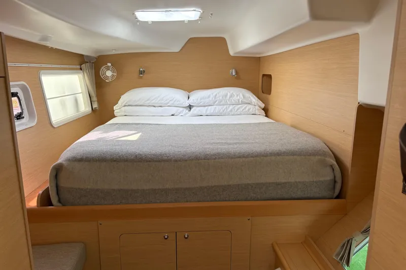 Too Impulsive Yacht Photos Pics Cozy cabin interior of 2014 Lagoon 380 S2 catamaran with comfortable bed and natural light.