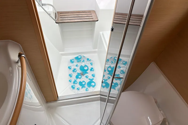 Too Impulsive Yacht Photos Pics Interior of 2014 Lagoon 380 S2 yacht bathroom with shower and wooden seat.