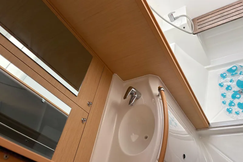 Too Impulsive Yacht Photos Pics Interior of 2014 Lagoon 380 S2 yacht bathroom with sink and shower area.