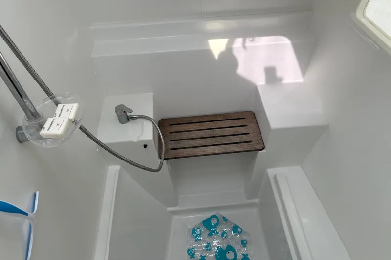 Too Impulsive Yacht Photos Pics Interior of 2014 Lagoon 380 S2 yacht shower with wooden bench and showerhead.