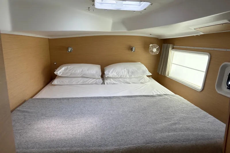 Too Impulsive Yacht Photos Pics Cozy cabin bedroom in 2014 Lagoon 380 S2 catamaran with double bed and window.