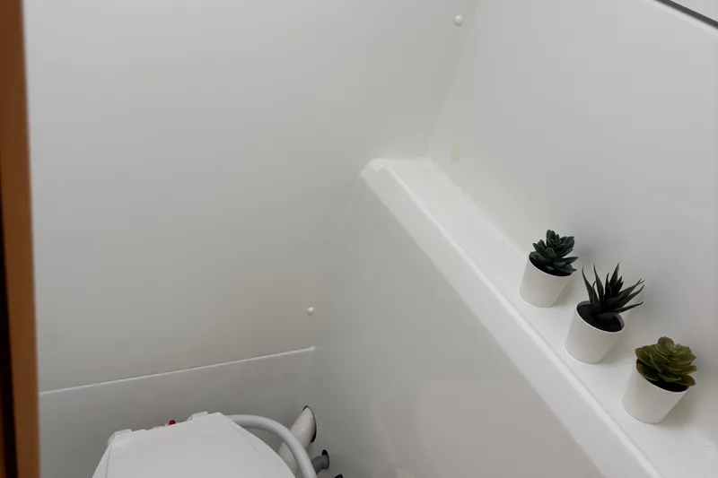 Too Impulsive Yacht Photos Pics Compact bathroom in 2014 Lagoon 380 S2 yacht with potted succulents.