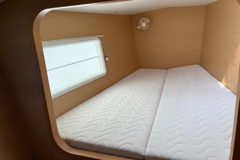 Too Impulsive Yacht Photos Pics Interior cabin of 2014 Lagoon 380 S2 catamaran with twin mattresses and window.