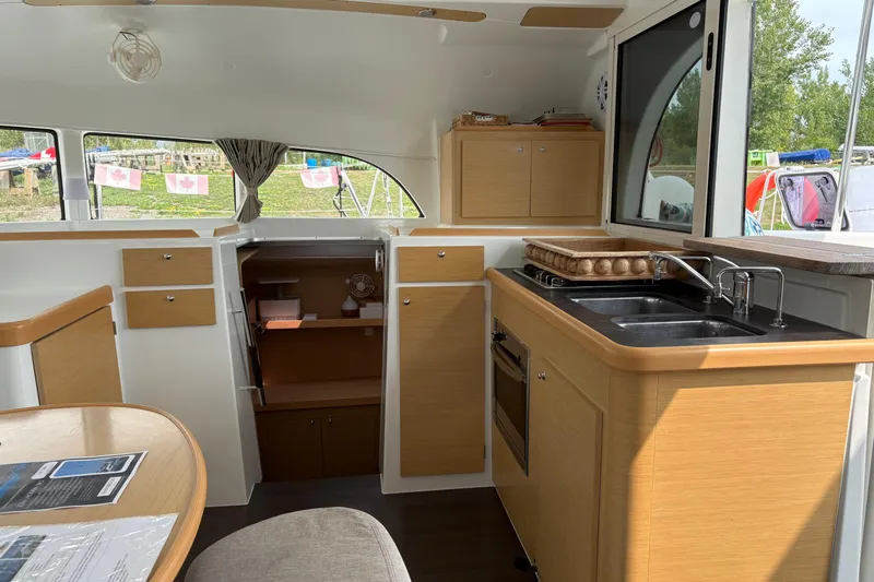Too Impulsive Yacht Photos Pics Interior of 2014 Lagoon 380 S2 catamaran with modern kitchen and dining area.