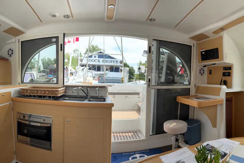 Too Impulsive Yacht Photos Pics Interior of 2014 Lagoon 380 S2 catamaran with modern kitchen and outdoor view.